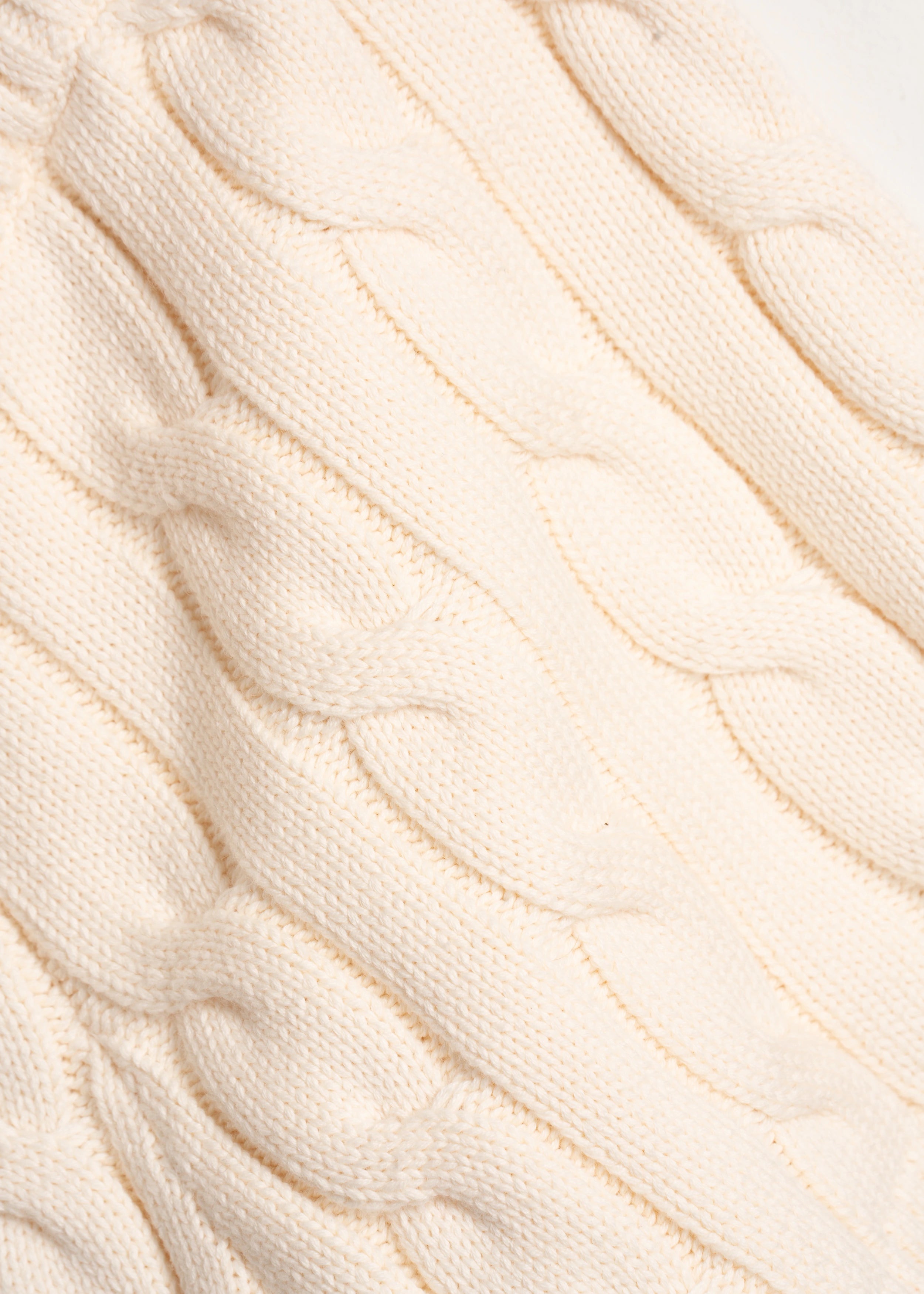 La Corsia Cable Knit Mini Short in cream, made from heavyweight cotton with a fitted silhouette, ribbed waistband, and chunky cable texture throughout.