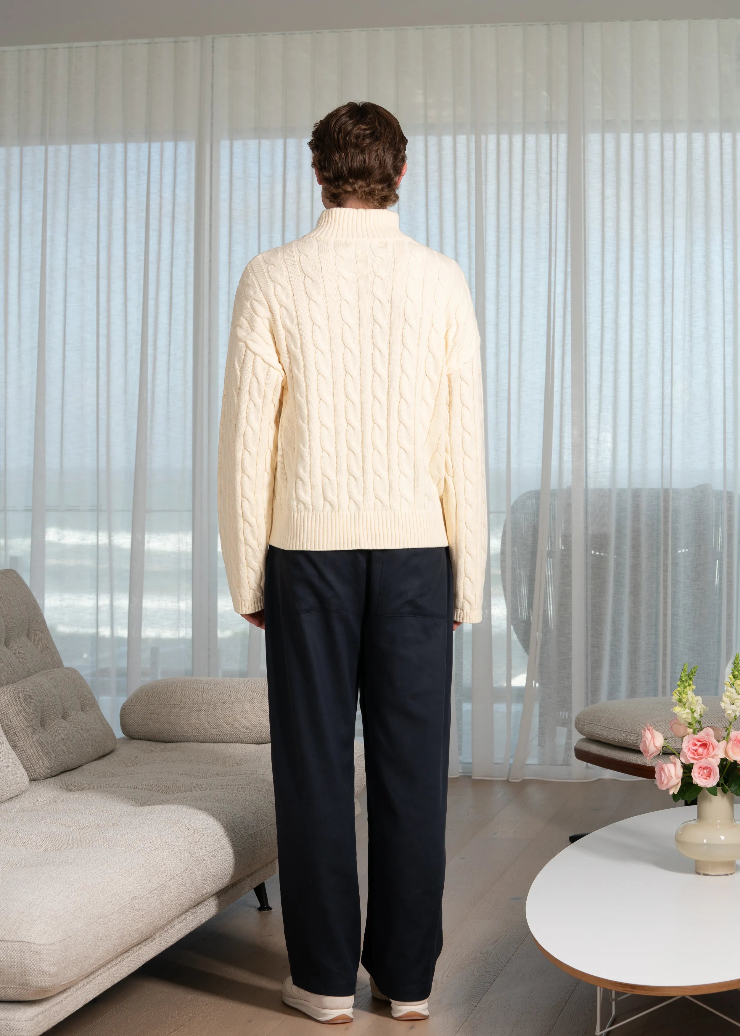 La Corsia Wide Sleeve Cable Knit sweater in cream, crafted from heavyweight cotton with a quarter zip, funnel neck, and sculpted oversized silhouette.