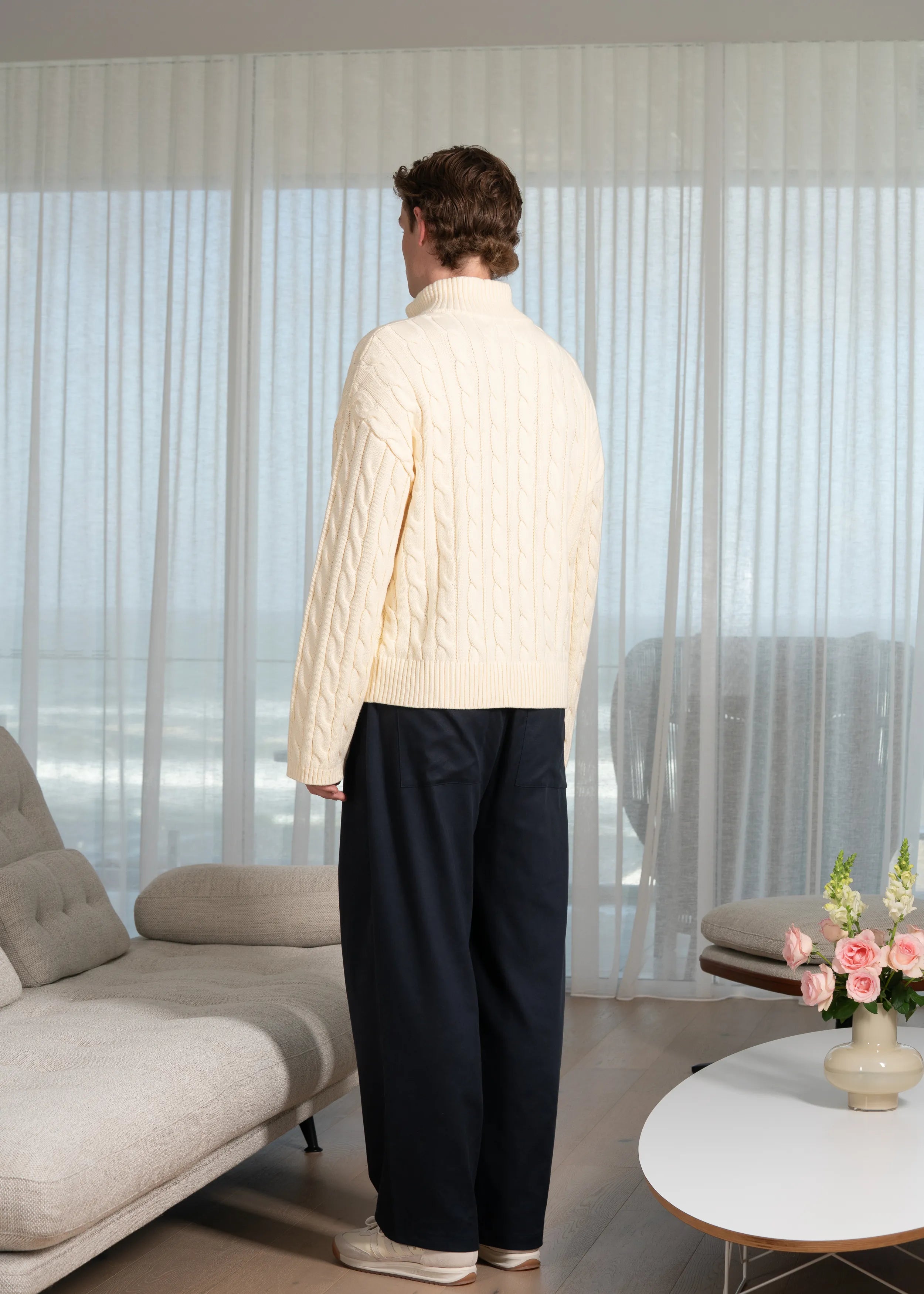 La Corsia Wide Sleeve Cable Knit sweater in cream, crafted from heavyweight cotton with a quarter zip, funnel neck, and sculpted oversized silhouette.