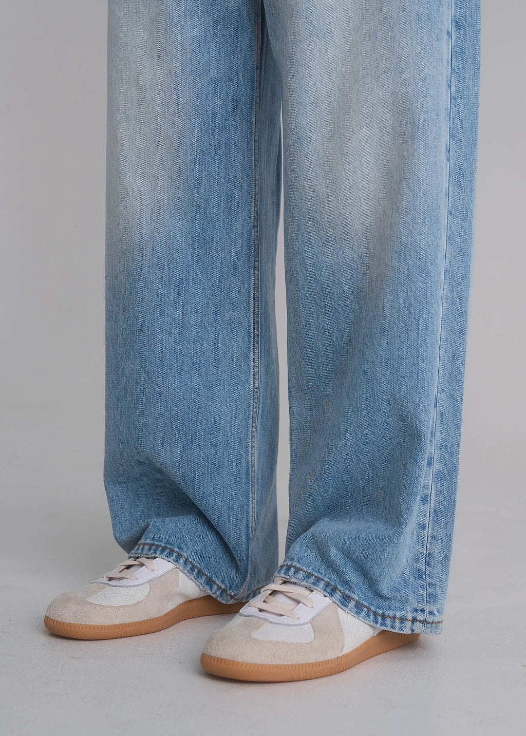Model wearing the La Corsia Vintage Wash Relaxed Denim in light blue