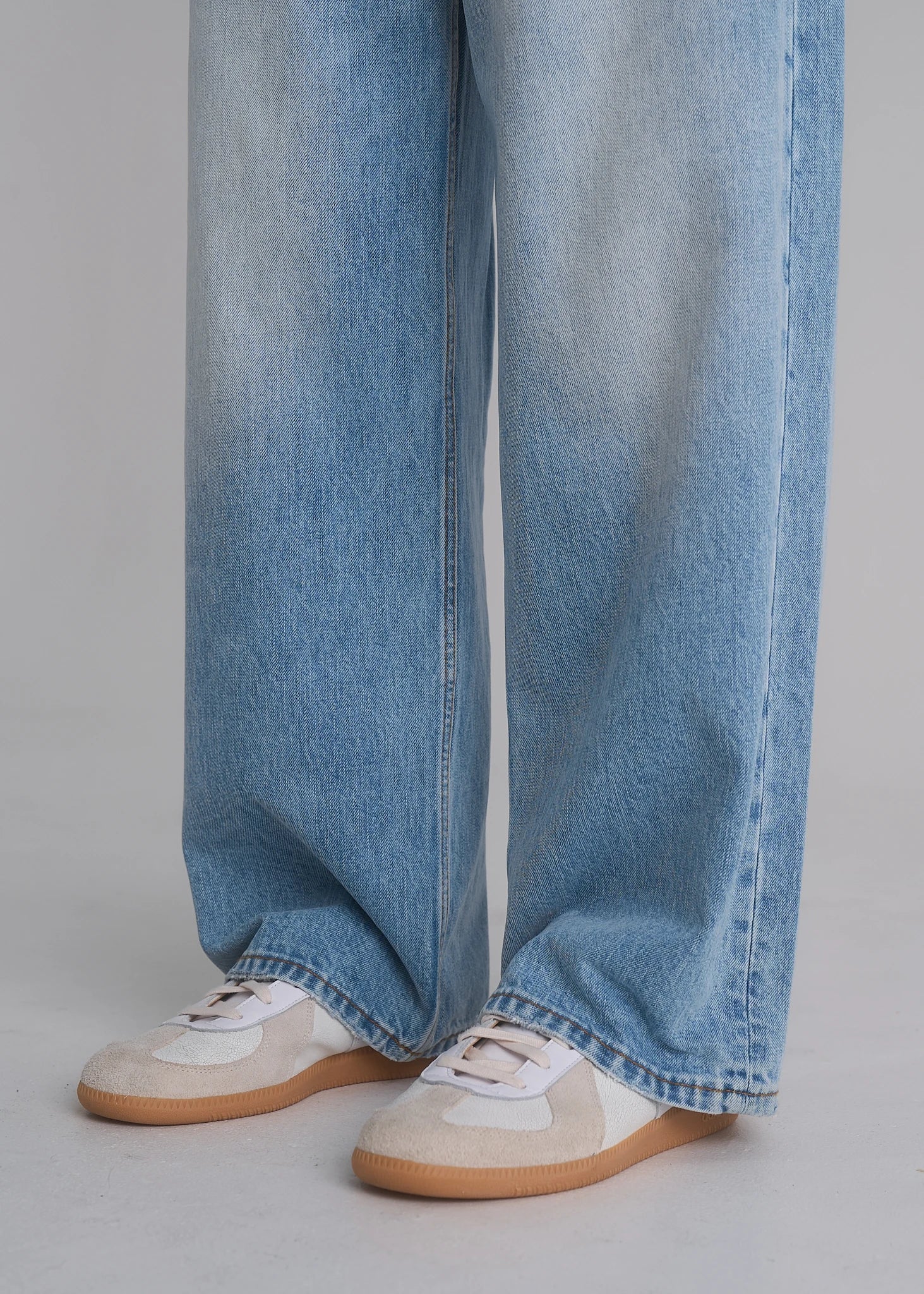 Model wearing the La Corsia Vintage Wash Relaxed Denim in light blue