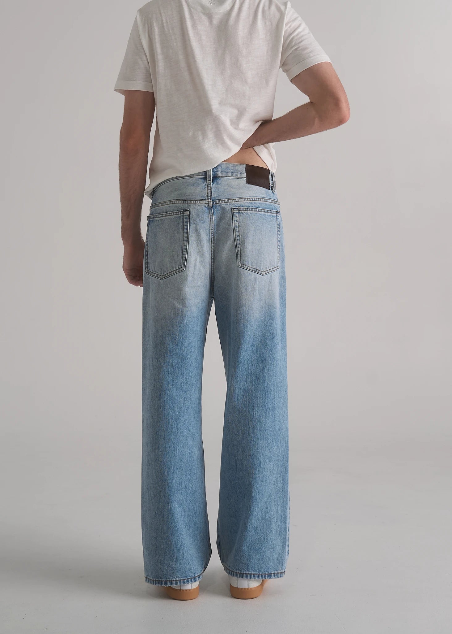 La Corsia Vintage Wash Relaxed Denim in light blue worn by a model on a plain studio background