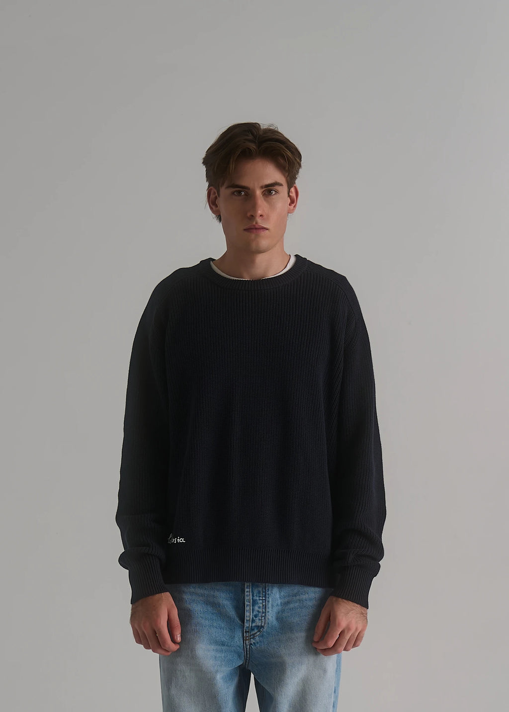 La Corsia Cotton Fisherman Sweater in deep navy worn by a model on a plain studio background