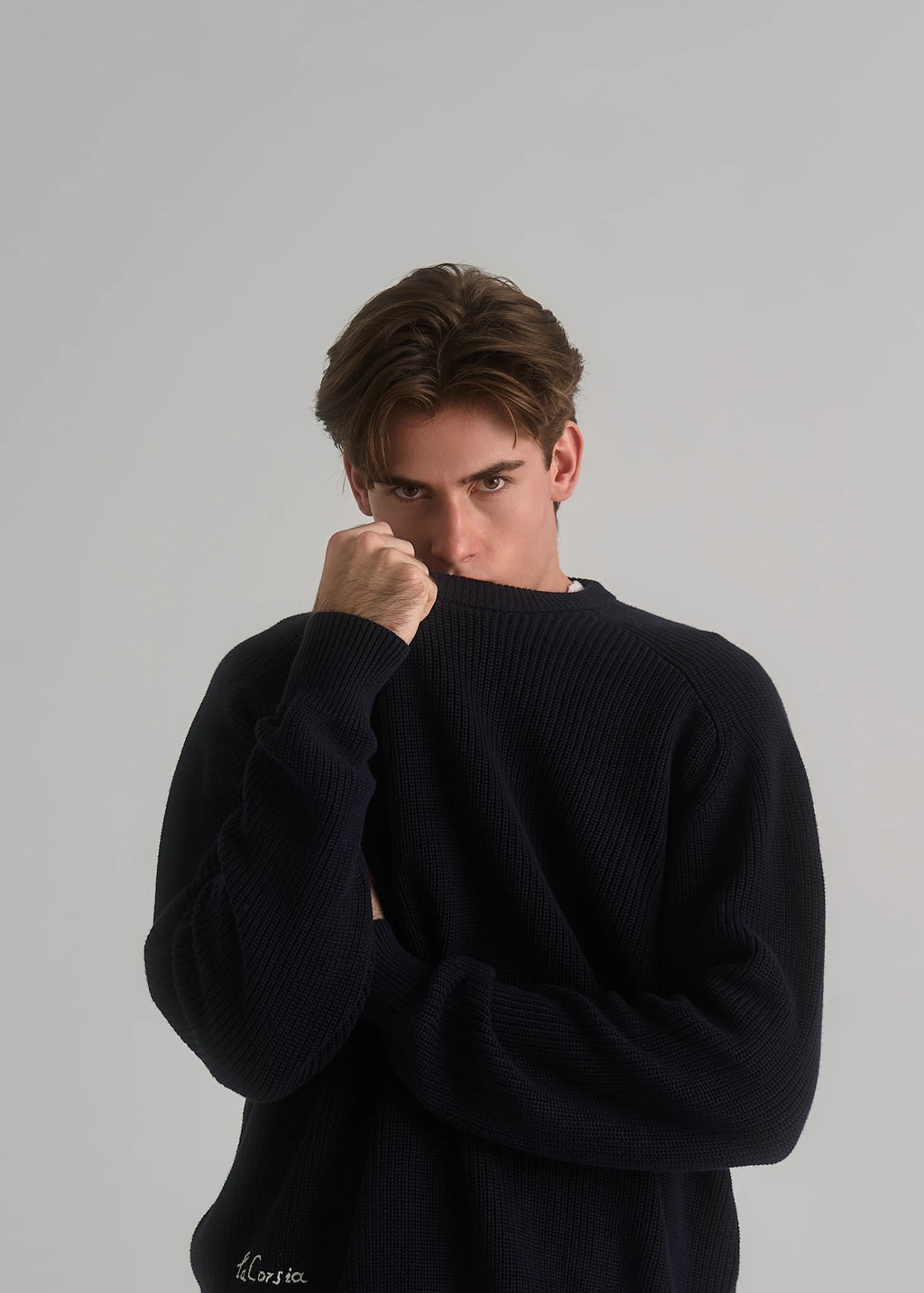 Model wearing the La Corsia Cotton Fisherman Sweater in deep navy
