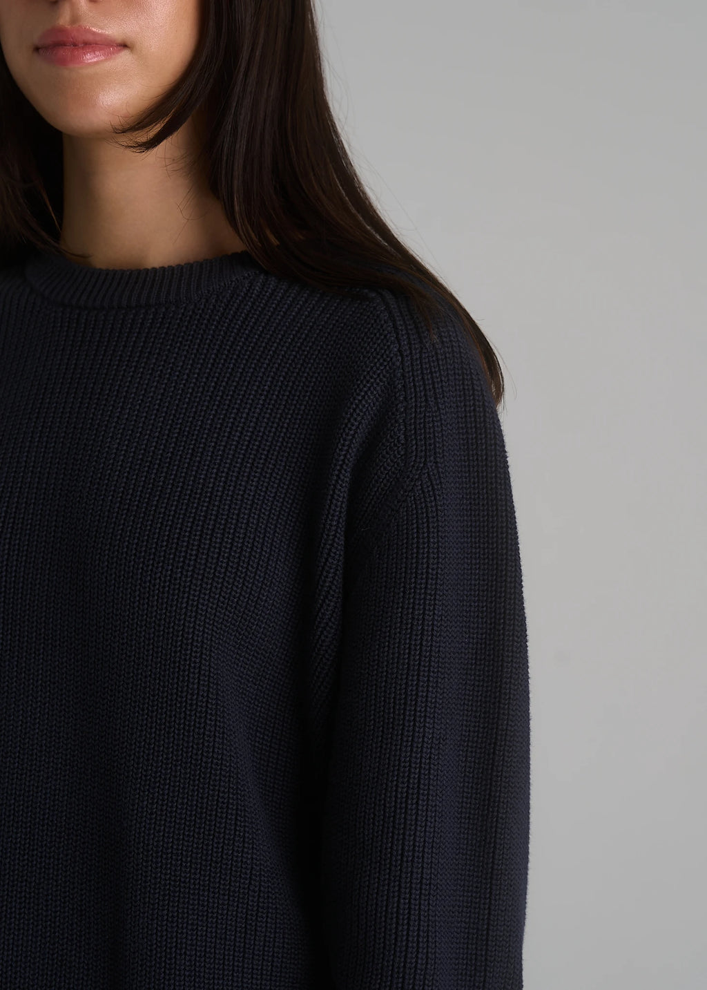 Model wearing the La Corsia Cotton Fisherman Sweater in deep navy
