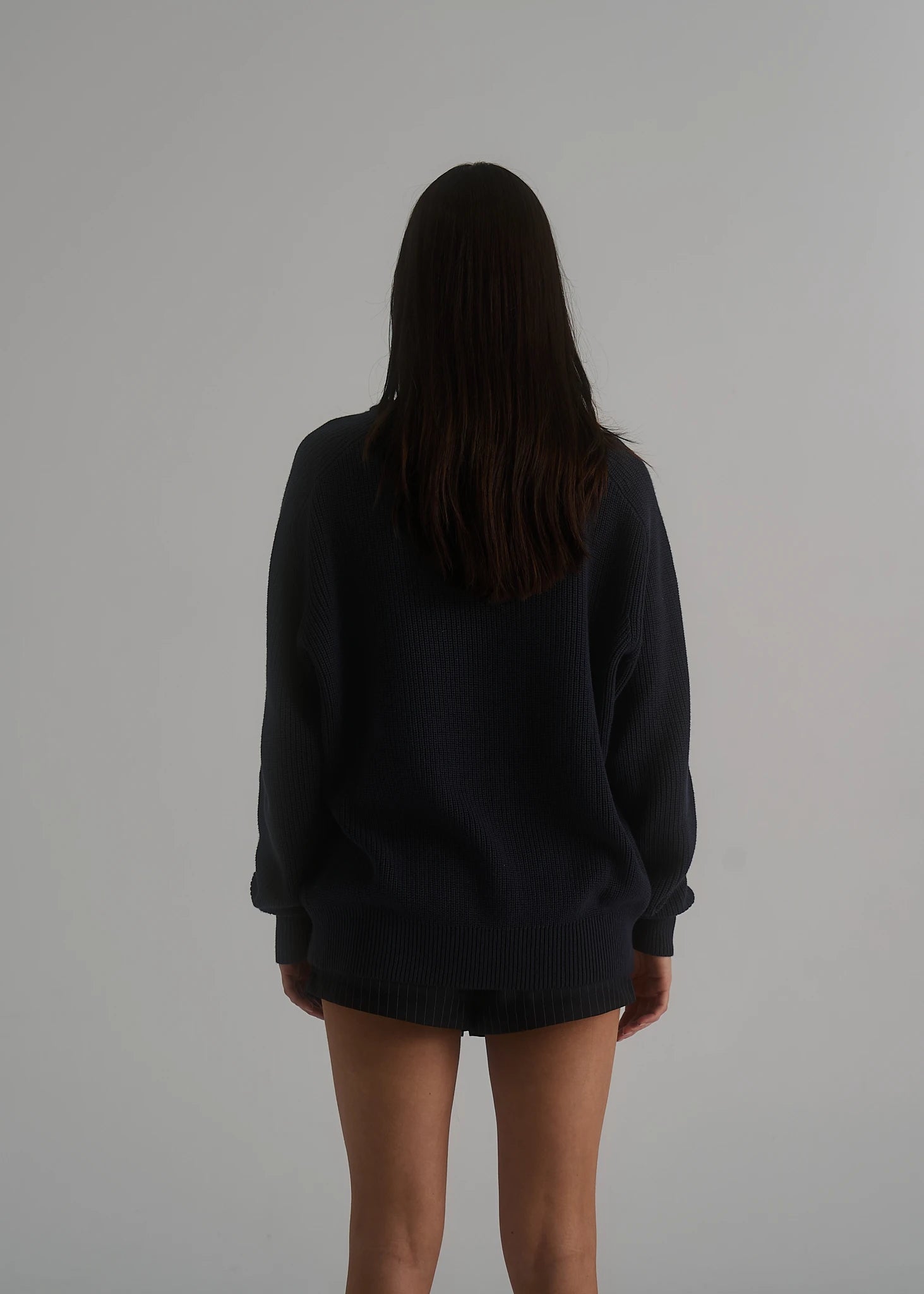 La Corsia Cotton Fisherman Sweater in deep navy worn by a model on a plain studio background