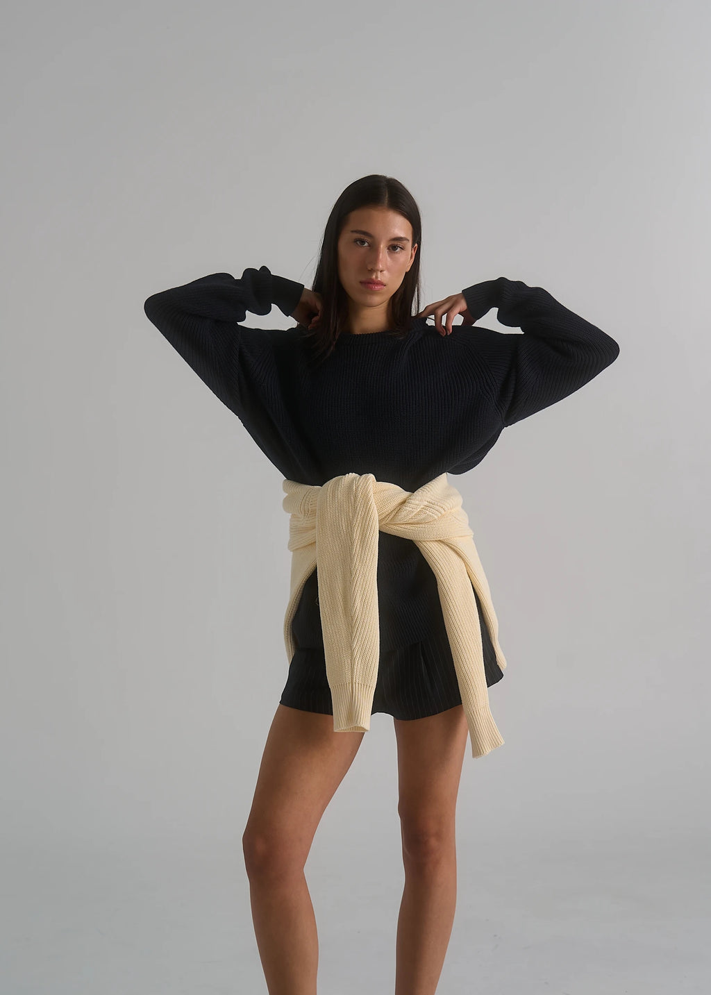 La Corsia Cotton Fisherman Sweater in deep navy worn by a model on a plain studio background