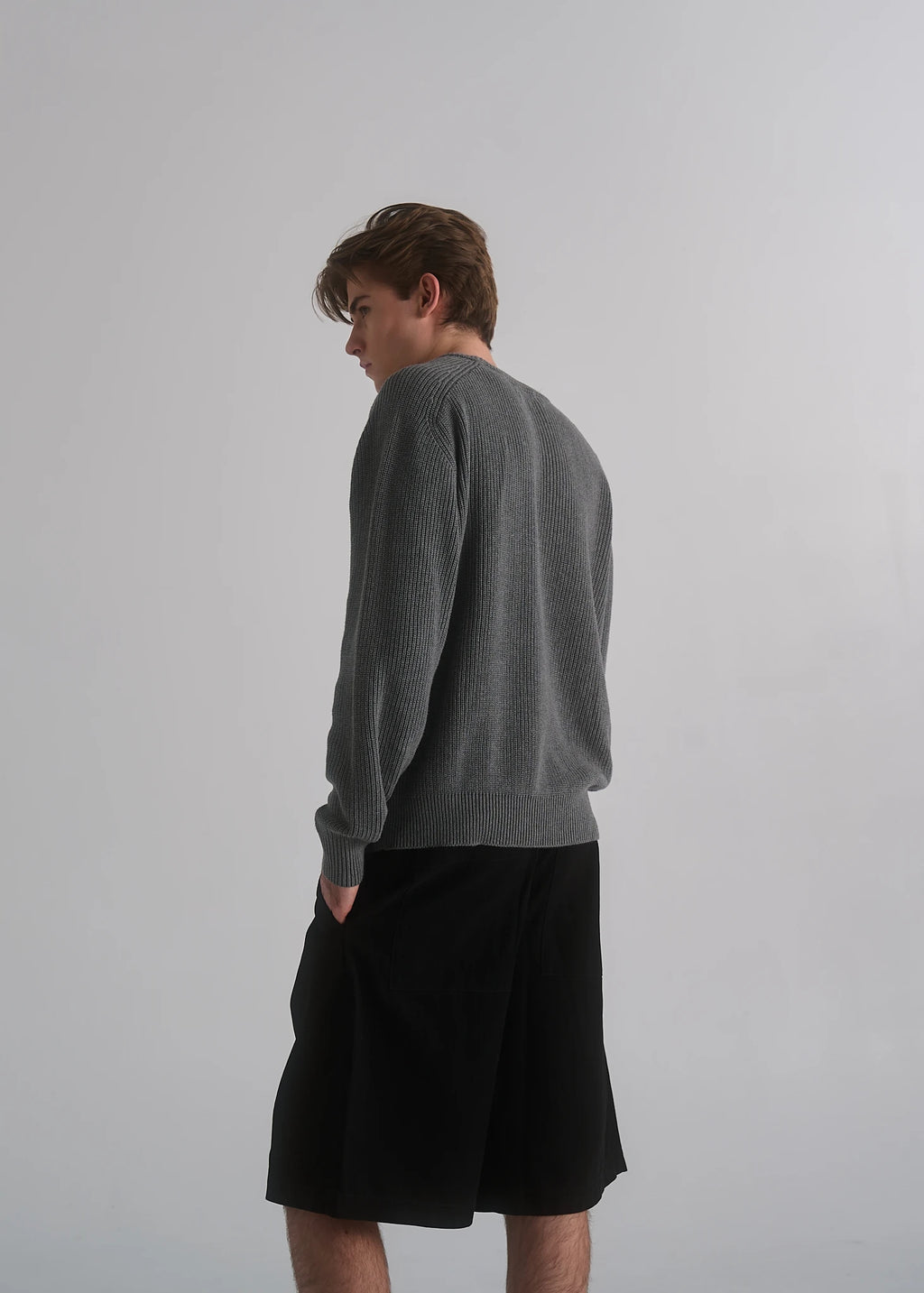 Model wearing the La Corsia Cotton Fisherman Sweater in grey marle
