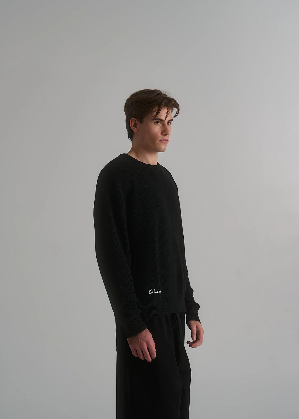 Model wearing the La Corsia Cotton Fisherman Sweater in black