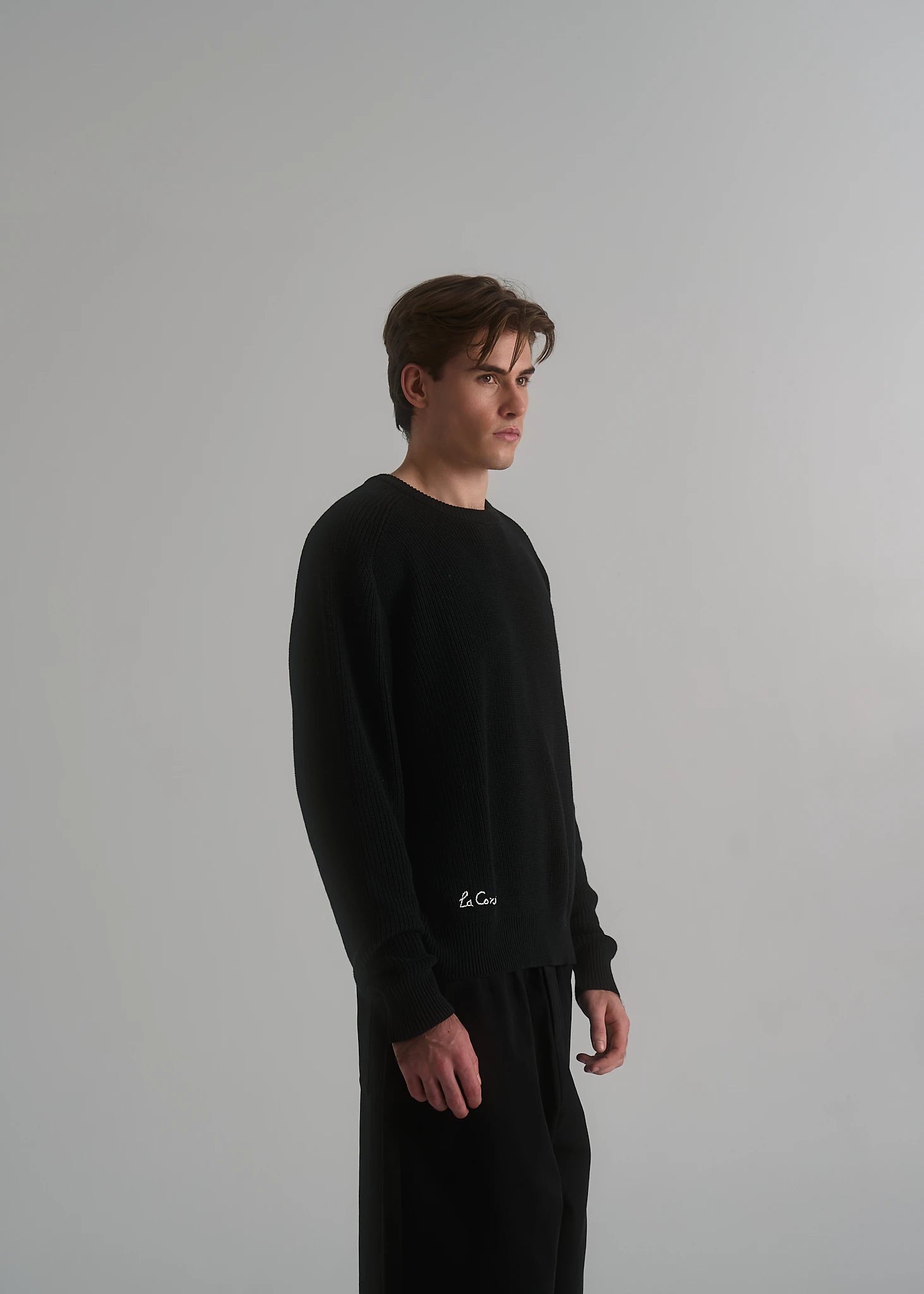 Model wearing the La Corsia Cotton Fisherman Sweater in black
