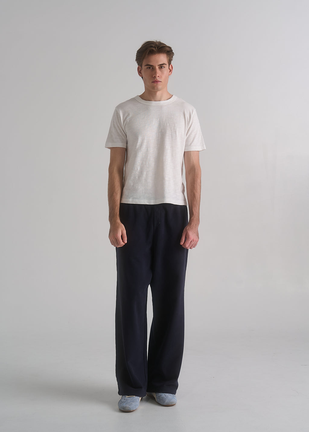 Model wearing the La Corsia Oversized Track Pant in washed navy