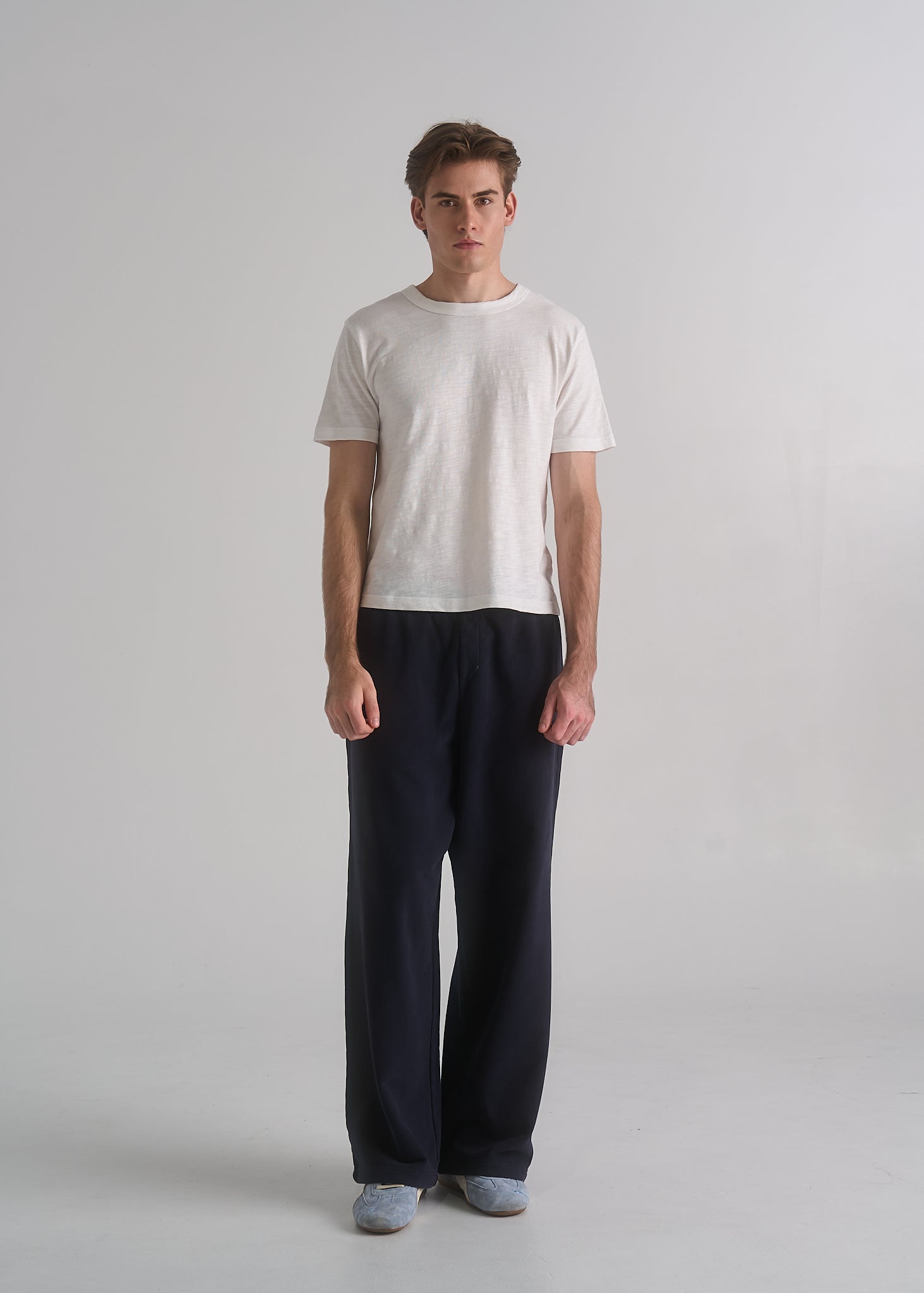 Model wearing the La Corsia Oversized Track Pant in washed navy