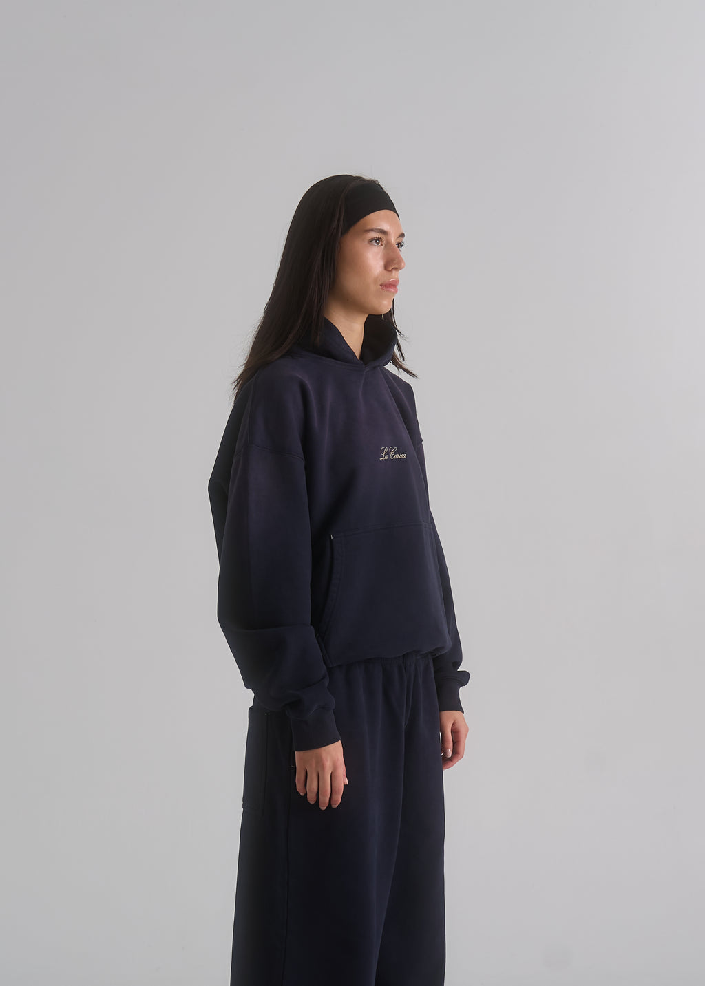 La Corsia Washed Script Hoodie in washed navy, studio model shot