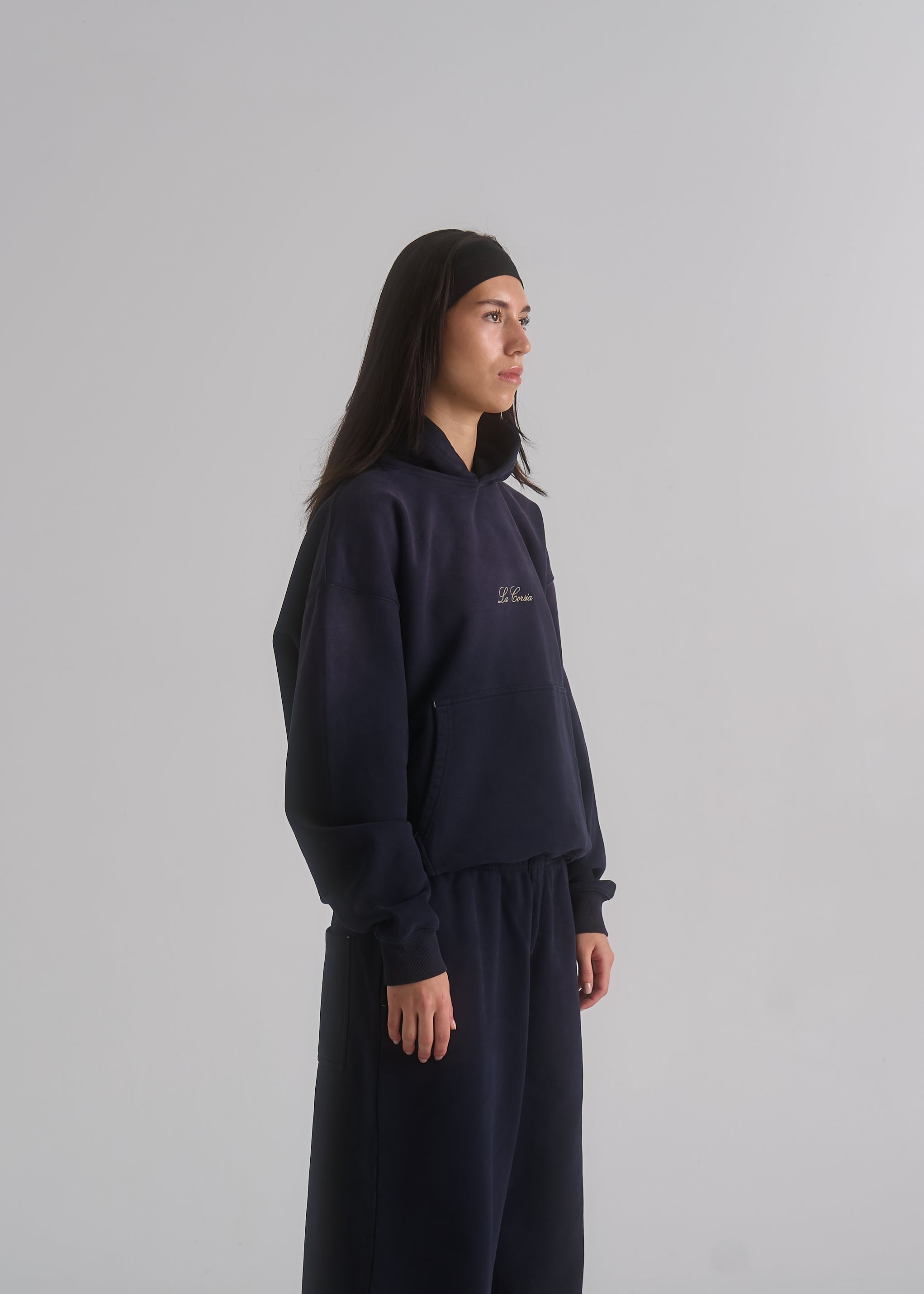 La Corsia Washed Script Hoodie in washed navy, studio model shot