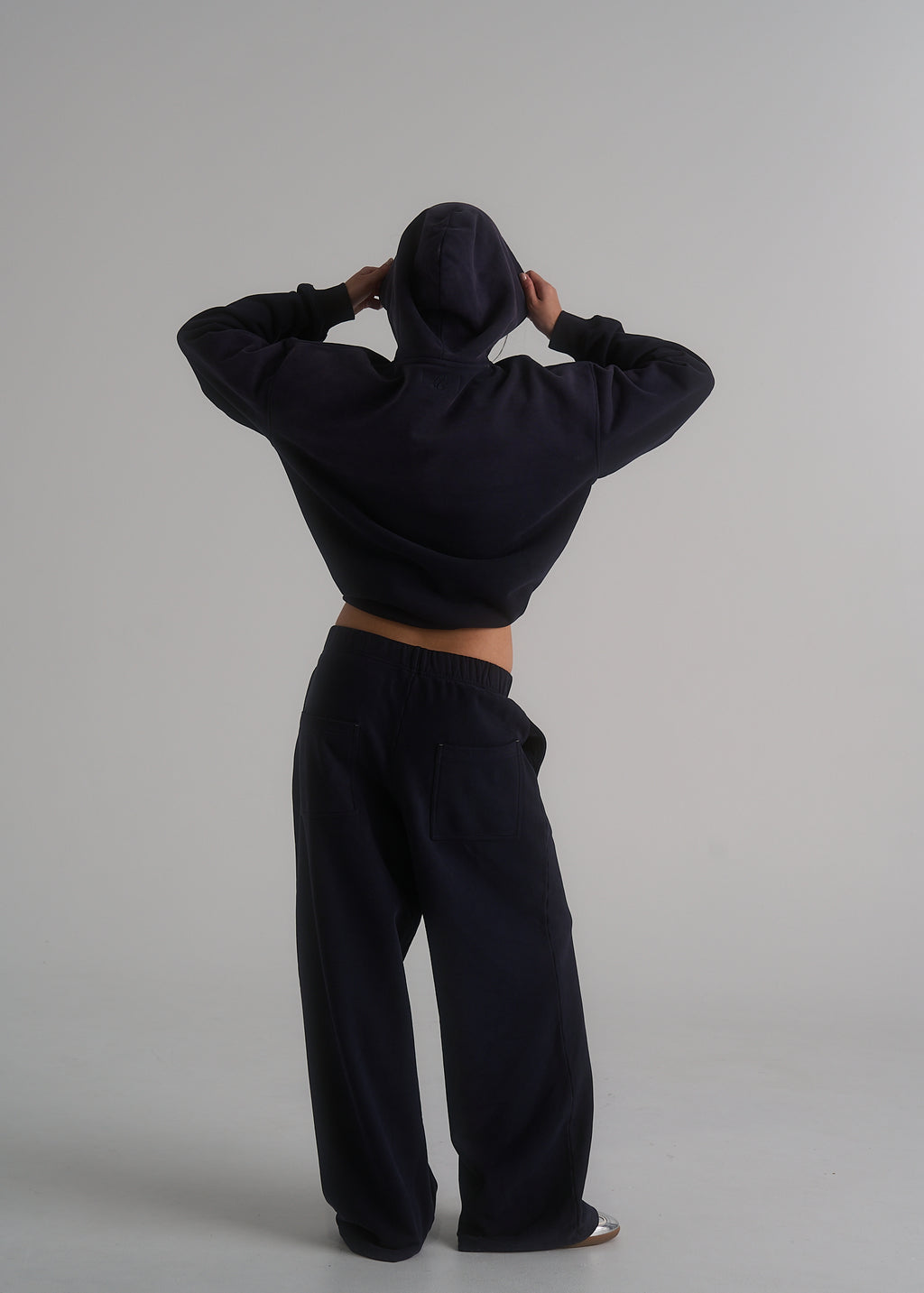 Model wearing the La Corsia Oversized Track Pant in washed navy