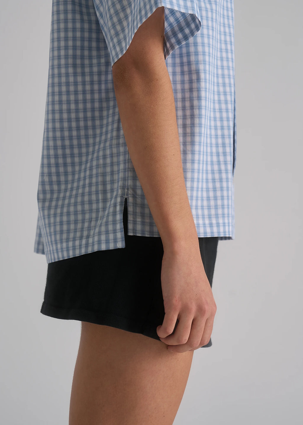 Model wearing the La Corsia Oversized Short Sleeve Shirt in light blue plaid