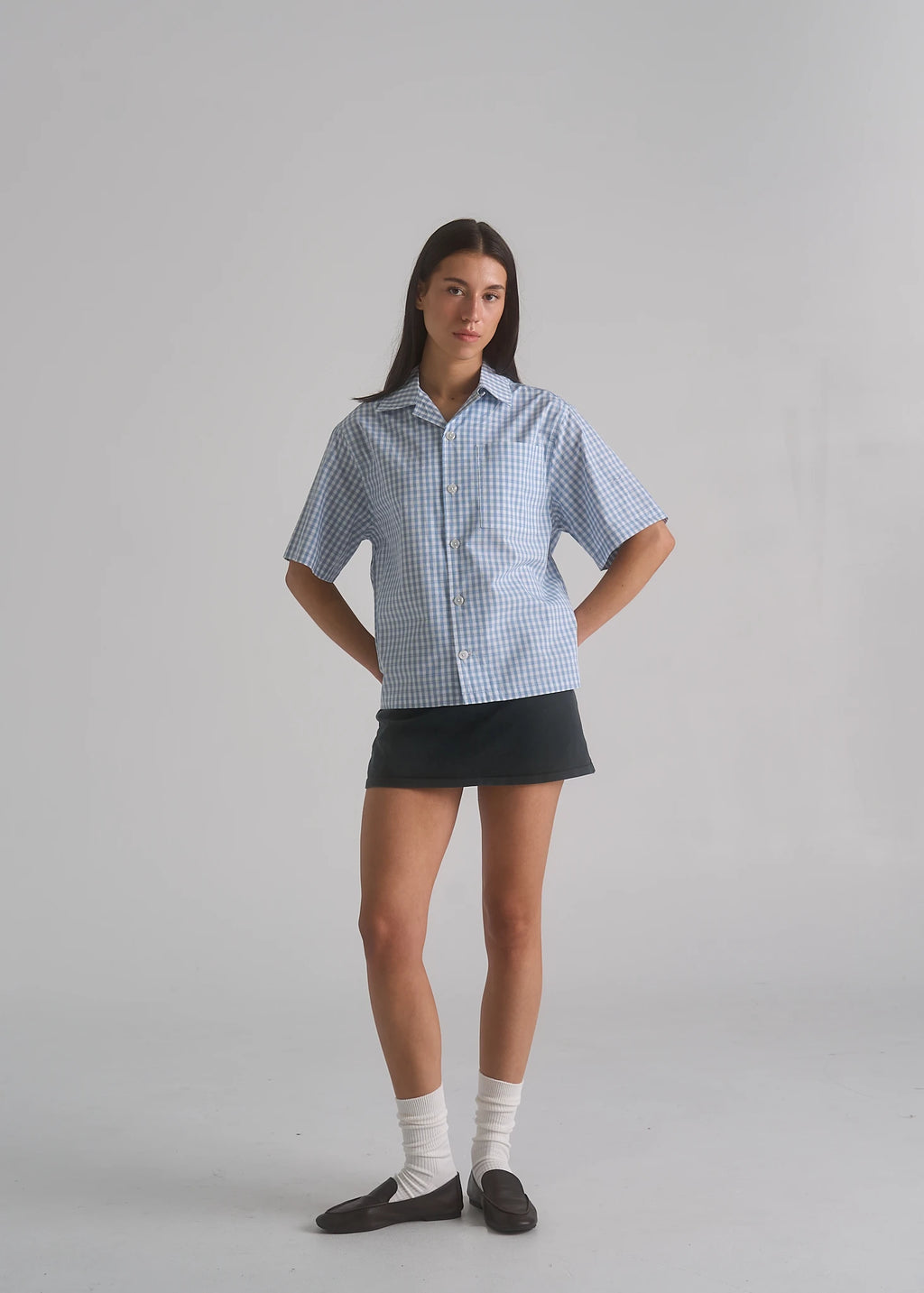 Model wearing the La Corsia Oversized Short Sleeve Shirt in light blue plaid
