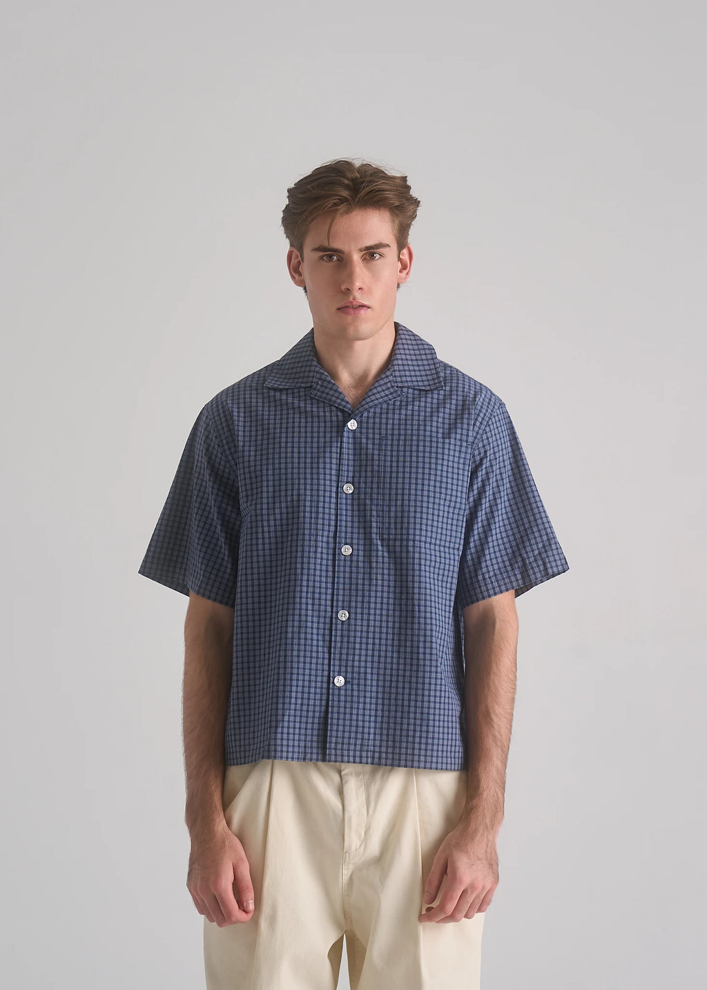 Model wearing the La Corsia Oversized Short Sleeve Shirt in dark blue check