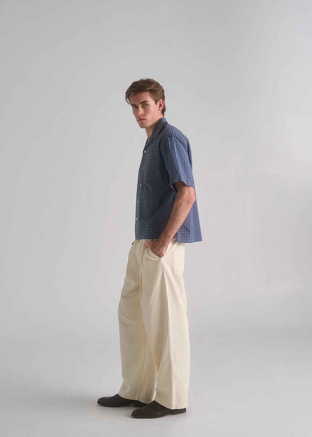 La Corsia Oversized Short Sleeve Shirt in dark blue check worn by a model on a plain studio background