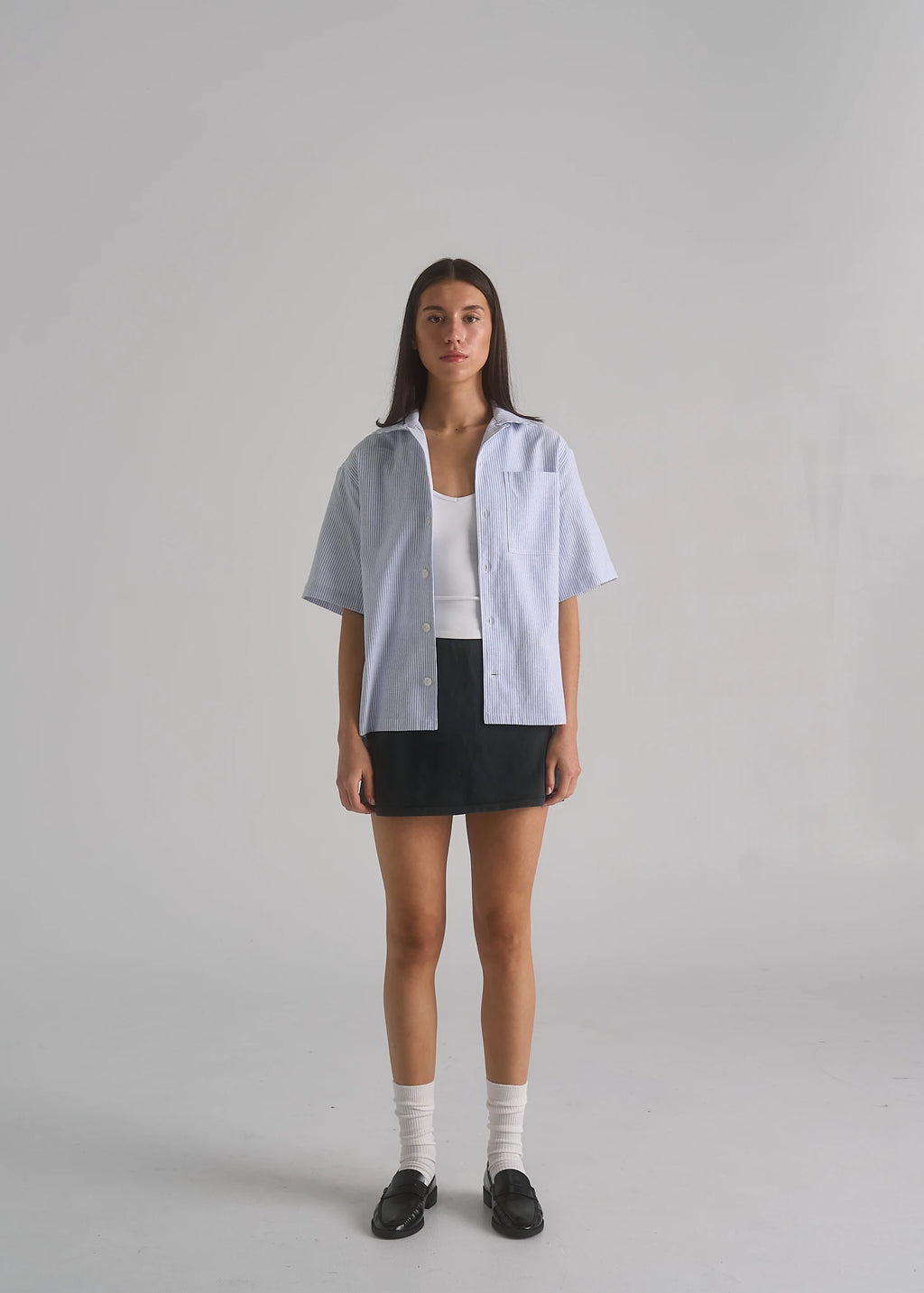 La Corsia Oversized Short Sleeve Shirt in oxford stripe worn by a model on a plain studio background