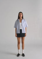 La Corsia Oversized Short Sleeve Shirt in oxford stripe worn by a model on a plain studio background