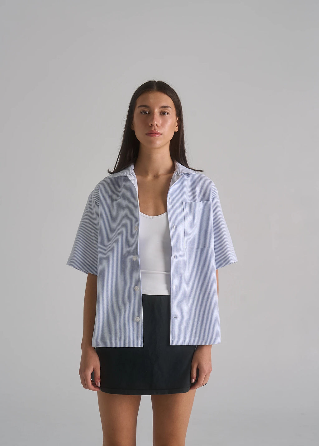 La Corsia Oversized Short Sleeve Shirt in oxford stripe worn by a model on a plain studio background