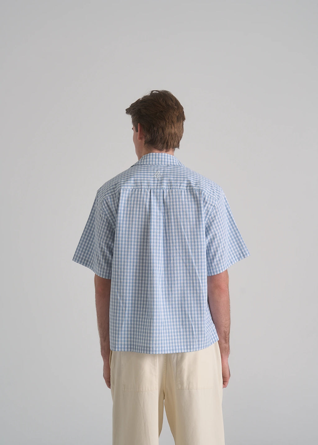 La Corsia Oversized Short Sleeve Shirt in light blue plaid worn by a model on a plain studio background