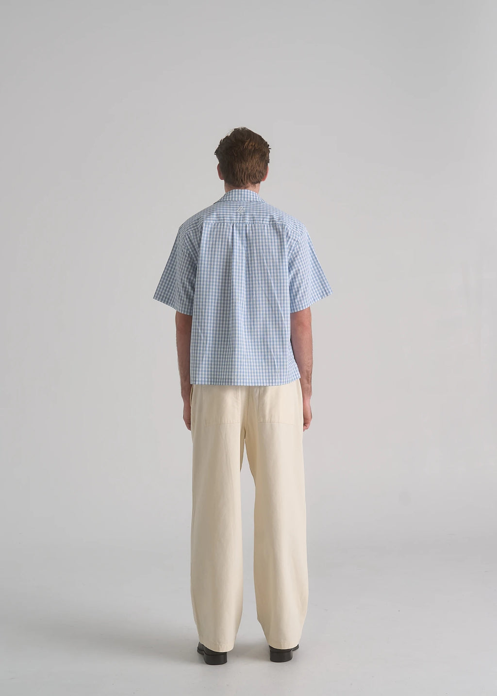 La Corsia Oversized Short Sleeve Shirt in light blue plaid worn by a model on a plain studio background