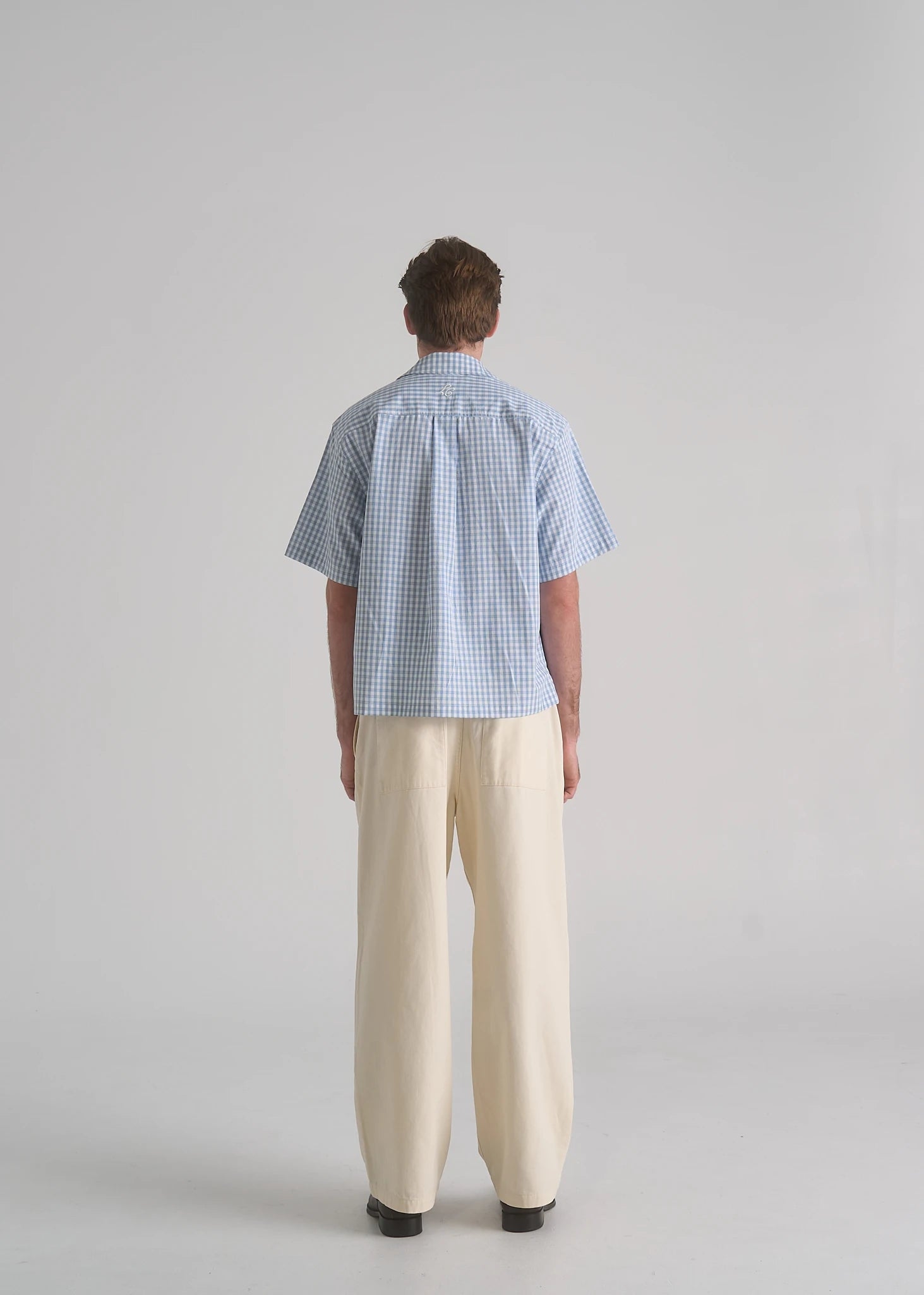 La Corsia Oversized Short Sleeve Shirt in light blue plaid worn by a model on a plain studio background