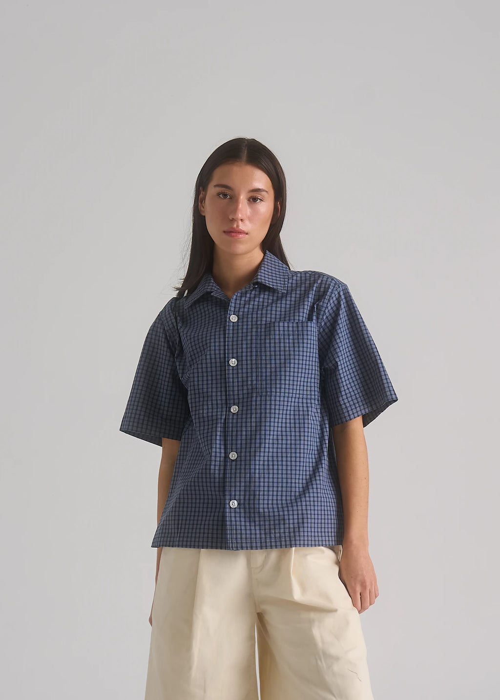 La Corsia Oversized Short Sleeve Shirt in dark blue check worn by a model on a plain studio background