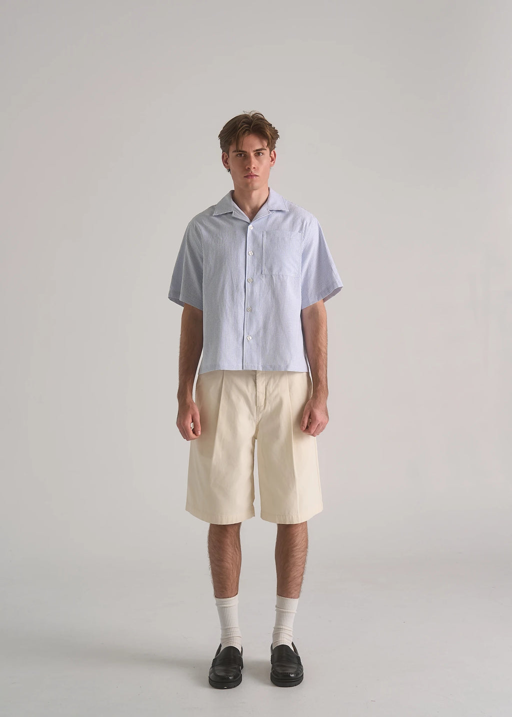 La Corsia Oversized Short Sleeve Shirt in oxford stripe worn by a model on a plain studio background