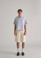 La Corsia Oversized Short Sleeve Shirt in oxford stripe worn by a model on a plain studio background