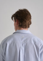 Model wearing the La Corsia Oversized Short Sleeve Shirt in oxford stripe