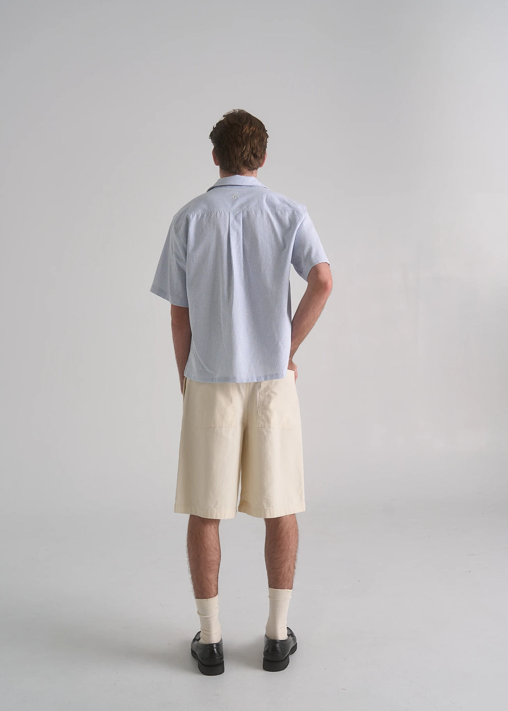 Model wearing the La Corsia Oversized Short Sleeve Shirt in oxford stripe