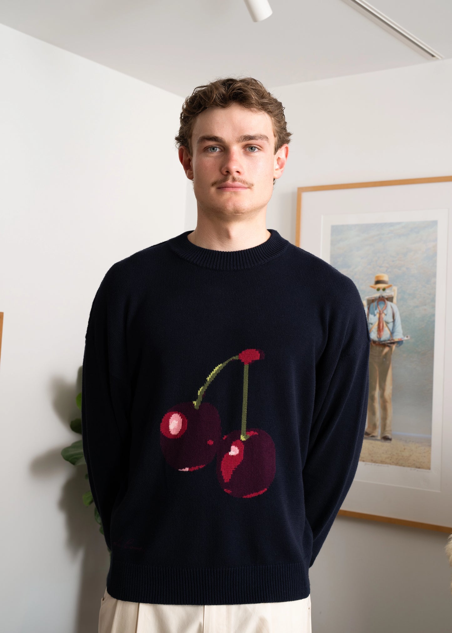 Closeup detailed intarsia knit photography of model wearing Cherry Intarsia Knit in studio.