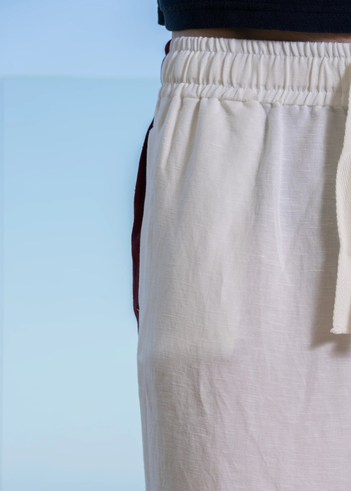 Closeup model waistband. Elasticated waistband with grosgrain drawcords. Side Seam Linen Pant