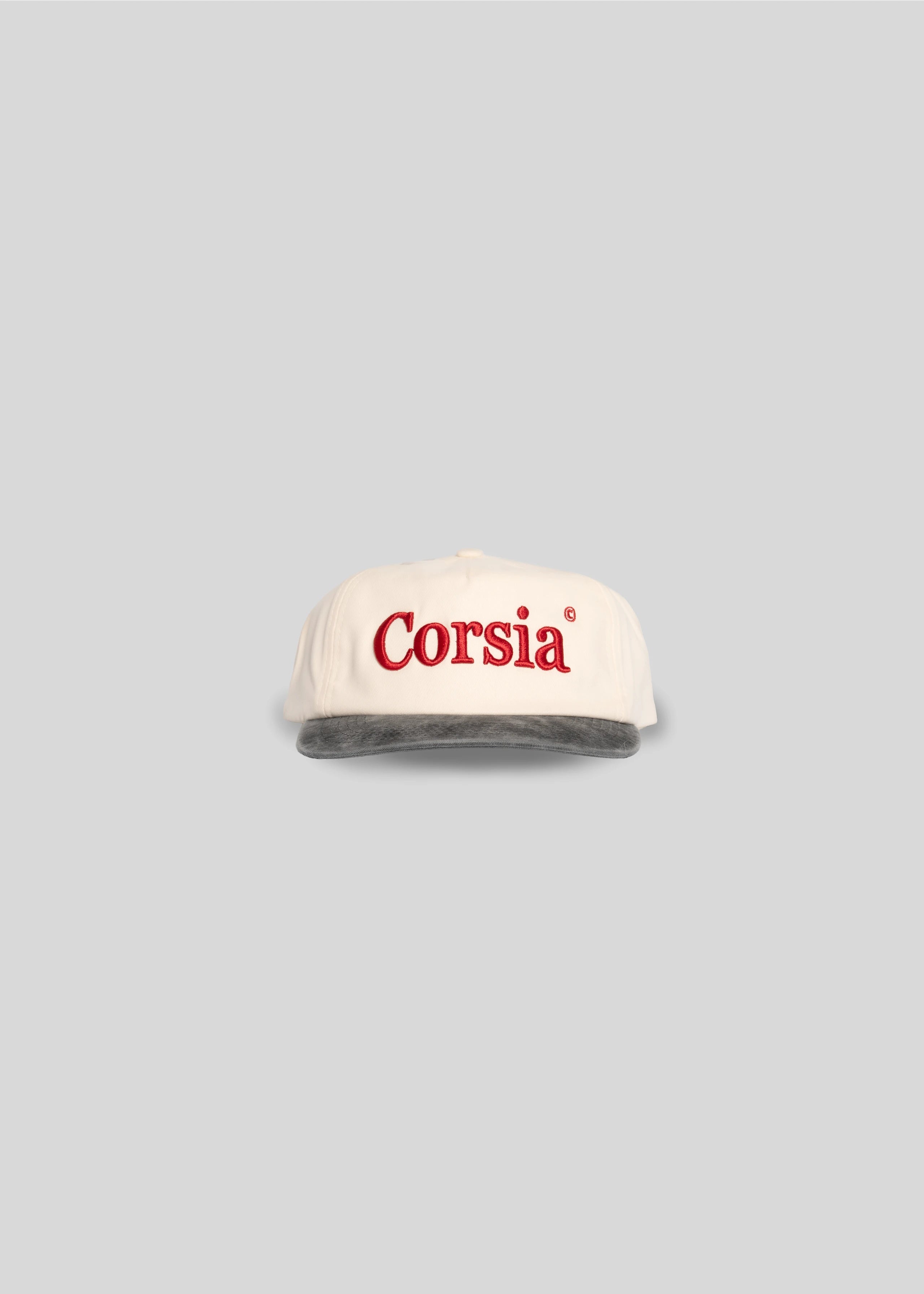 White cap with 'Corsia' logo on a gray background