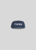 Navy blue cap with 'Corsia' text on a light gray background