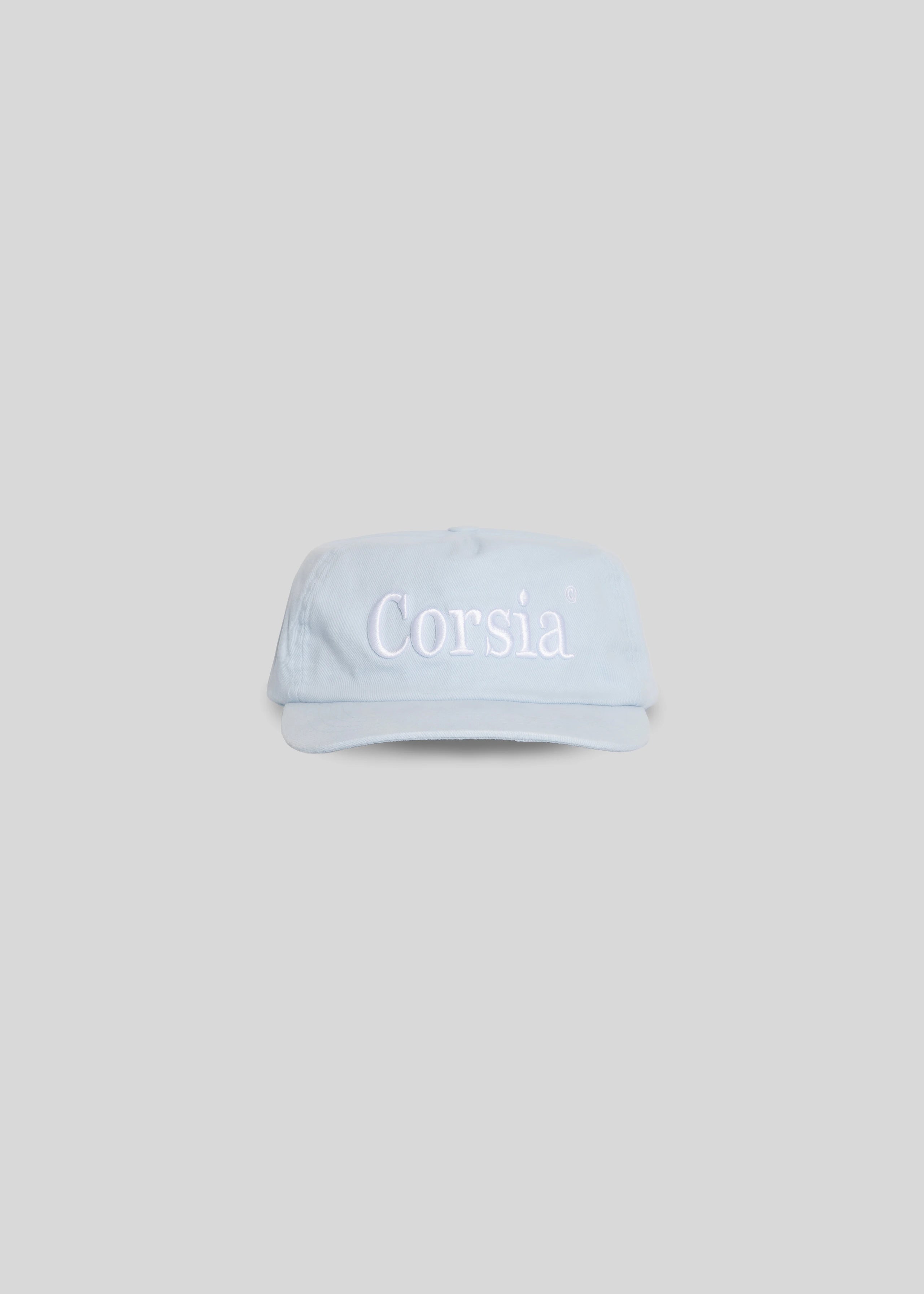 Light blue visor cap with 'Corsia' branding on a light gray background