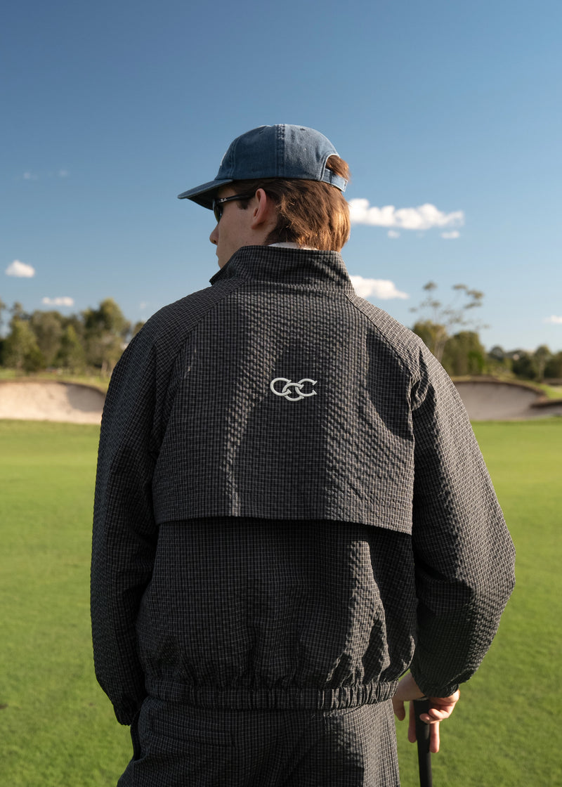 Corsia Country Club Windbreaker in navy check worn on the golf course