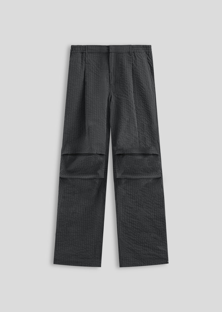 Corsia Country Club Pant in navy check, flat lay on a plain background