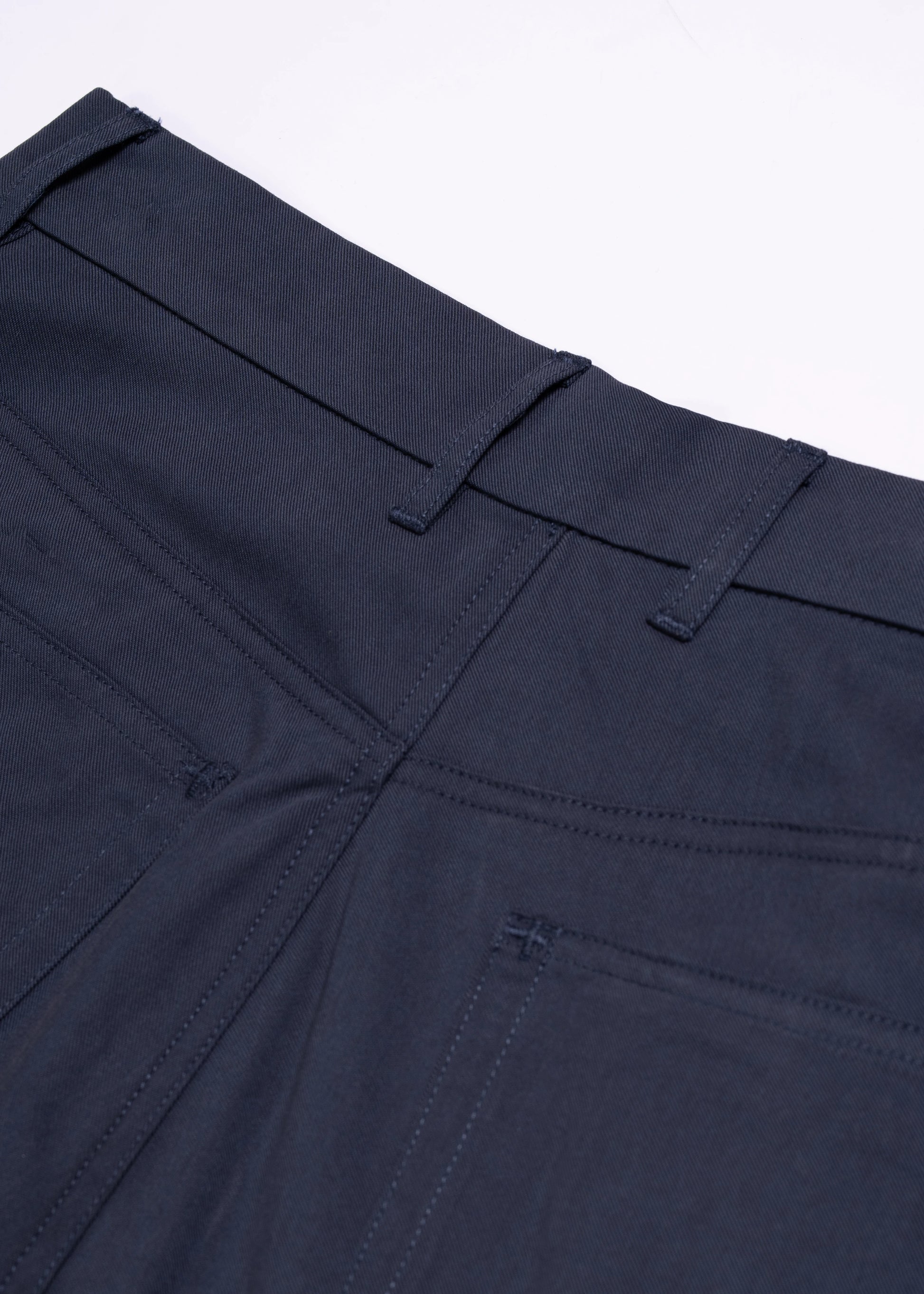 Flat lay photography of the back pockets of wide leg pleated shorts in Navy. La Corsia summer collection 2024. 