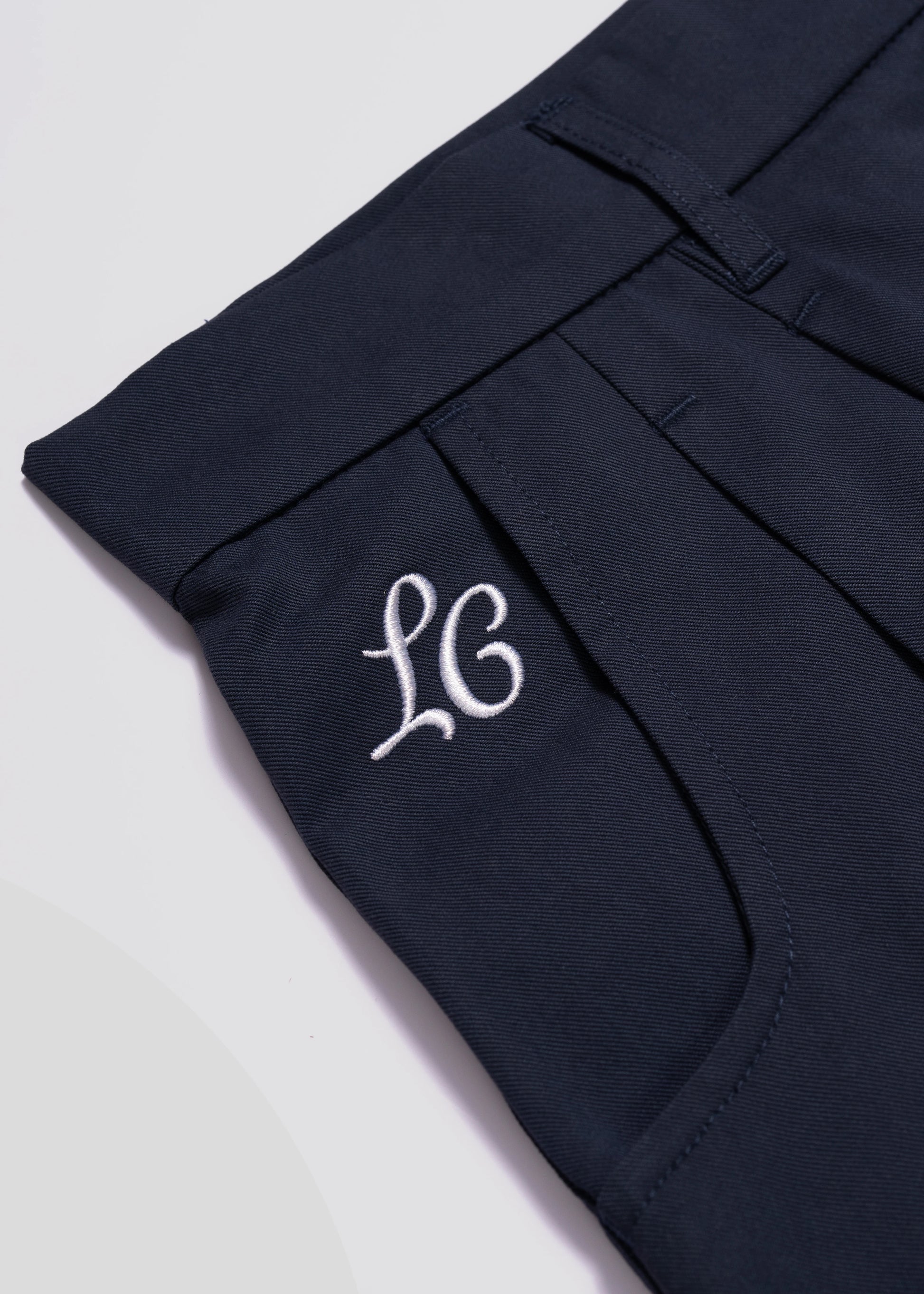 Detailed front flat lay photography of the wide leg pleated shorts in Navy. La Corsia summer collection 2024. 