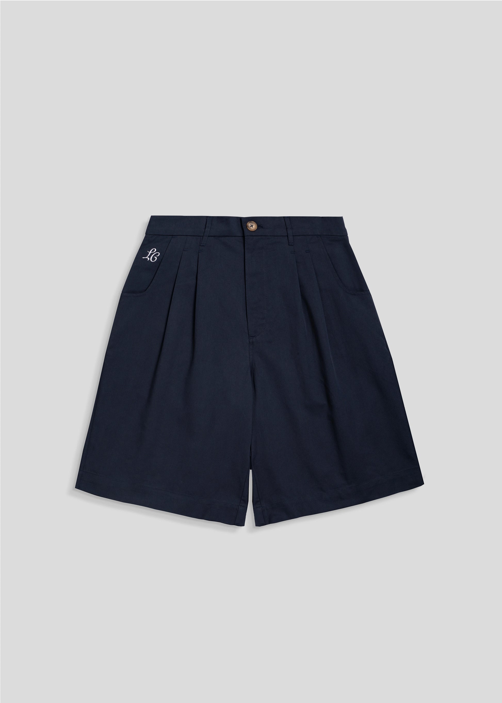 Flat lay photography of the wide leg pleated shorts in Navy. La Corsia summer collection 2024. 