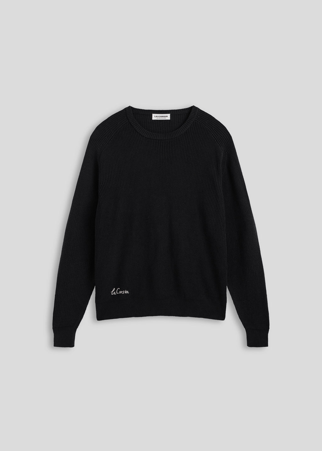La Corsia Cotton Fisherman Sweater in black, flat lay on a plain background