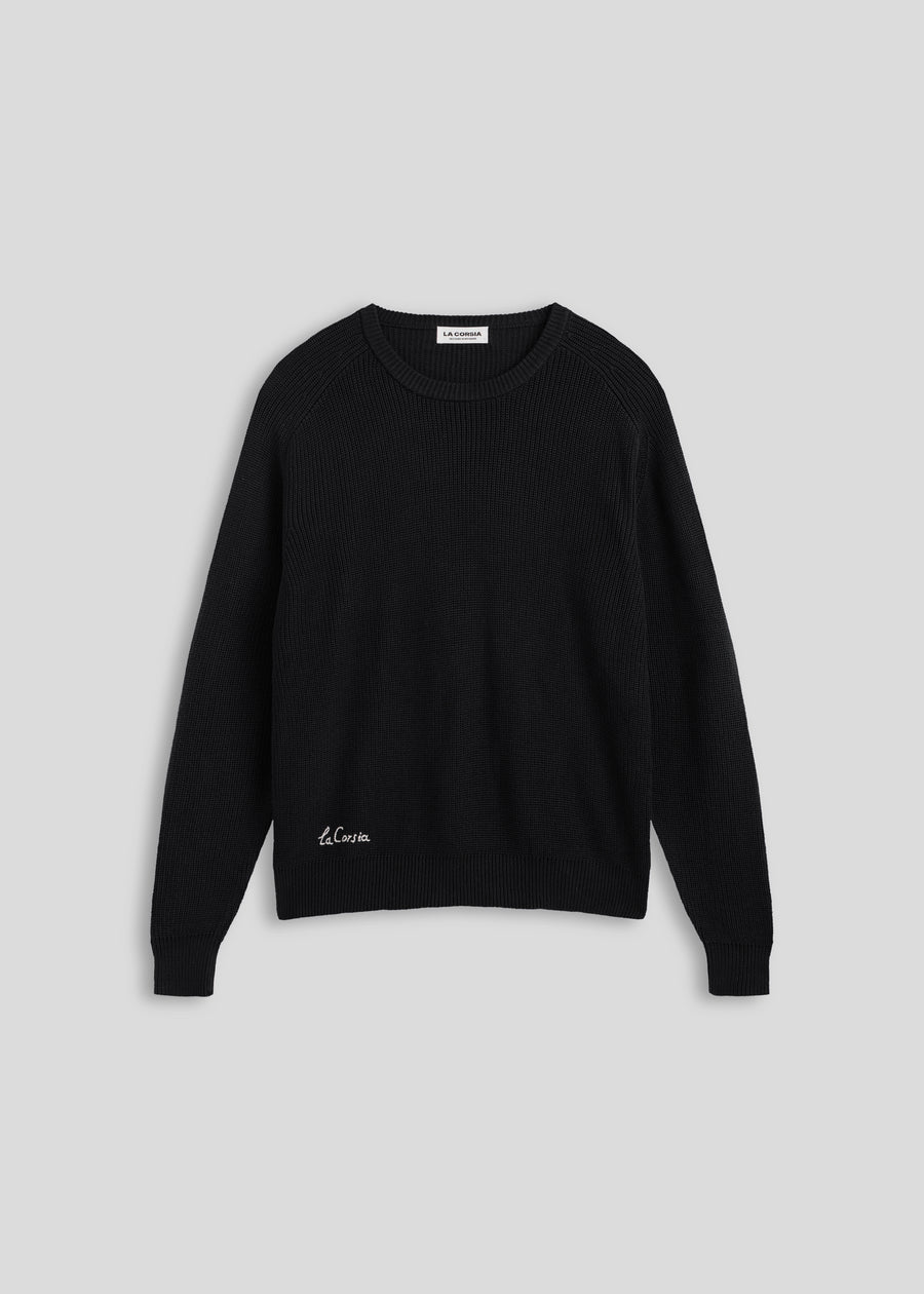 La Corsia Cotton Fisherman Sweater in black, flat lay on a plain background
