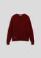 La Corsia Cotton Fisherman Sweater in wine red, flat lay on a plain background