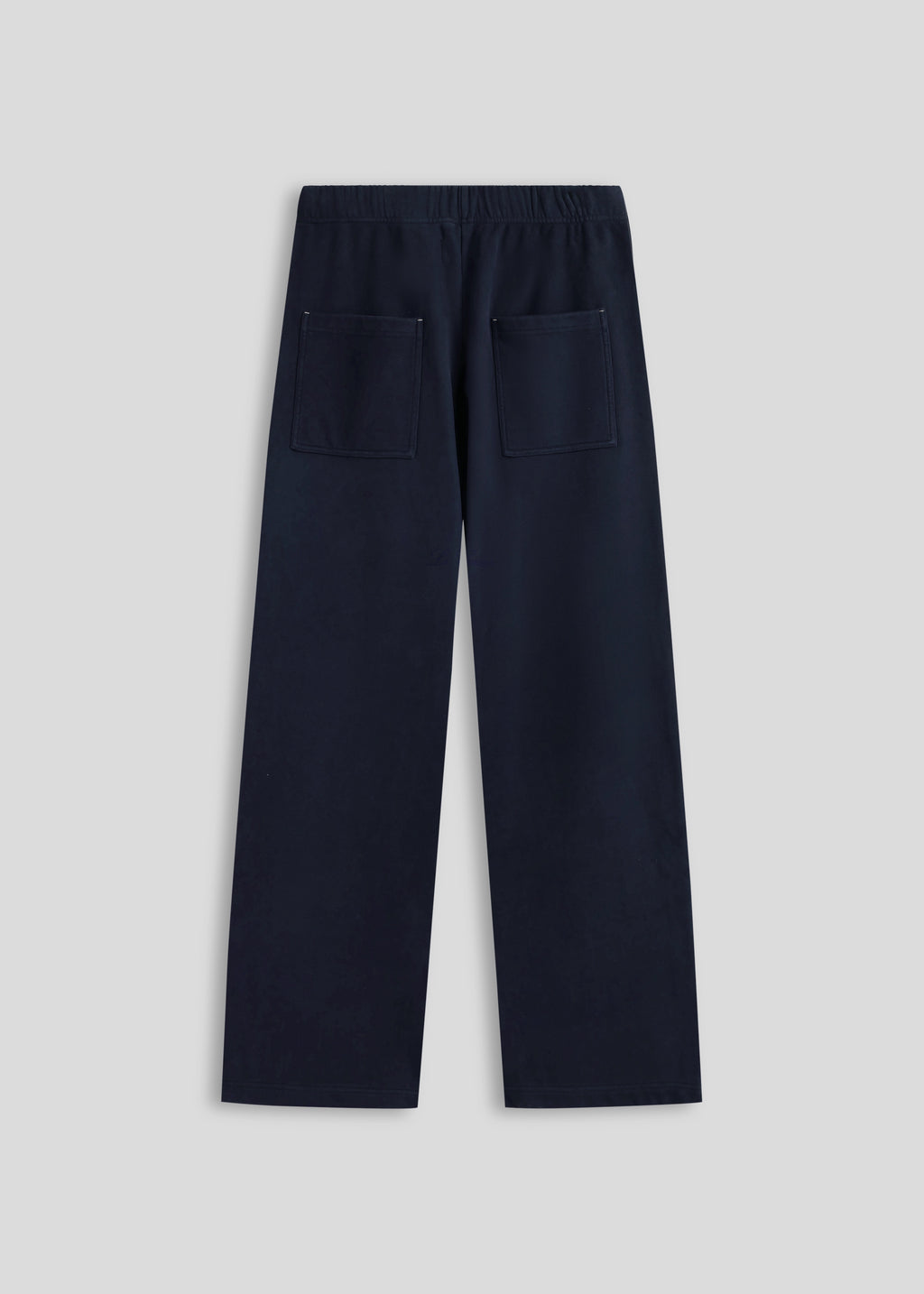 La Corsia Oversized Track Pant in washed navy worn by a model on a plain studio background
