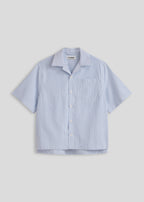 La Corsia Oversized Short Sleeve Shirt in oxford stripe, flat lay on a plain background
