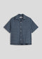 La Corsia Oversized Short Sleeve Shirt in dark blue check, flat lay on a plain background